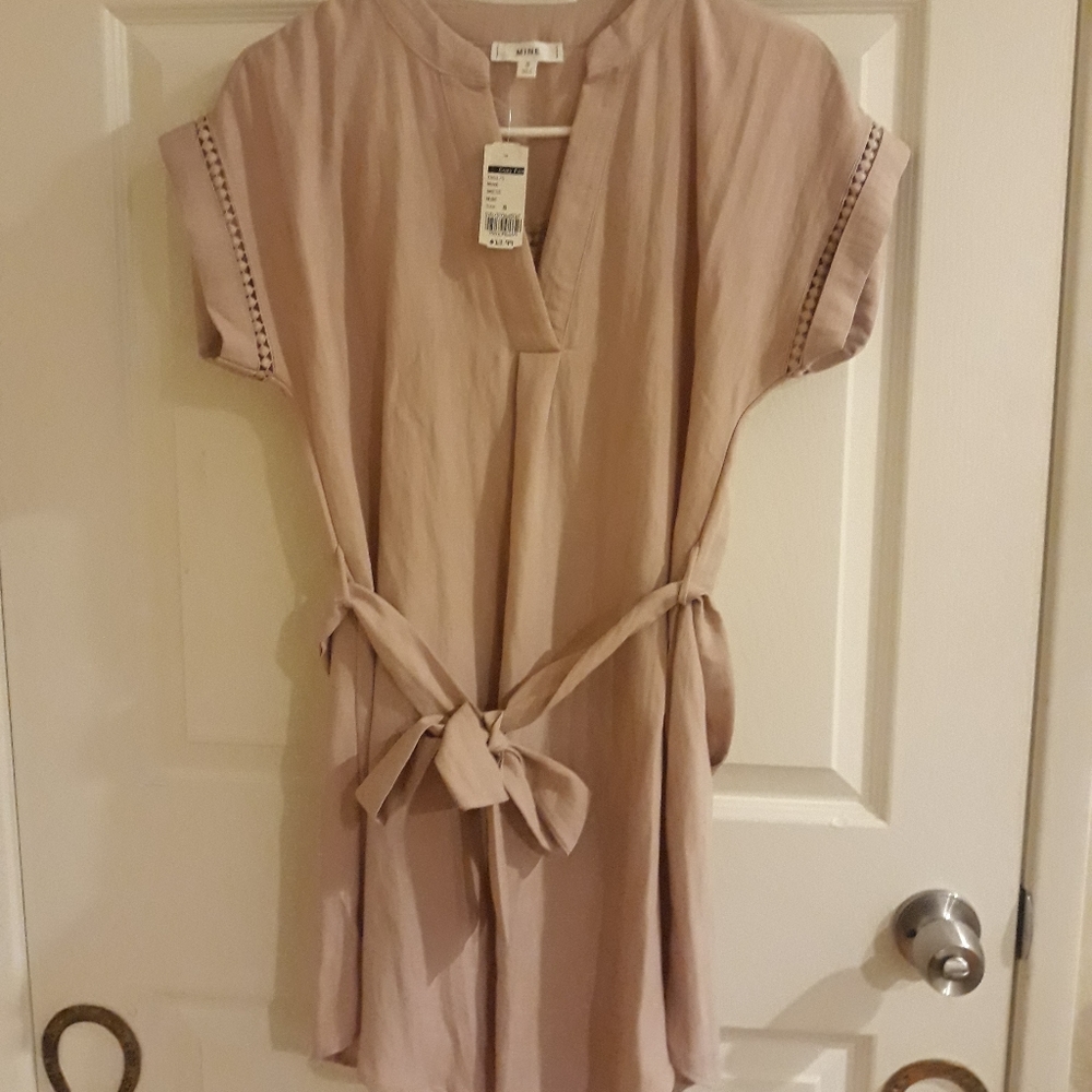 Nude colored dress with tie.